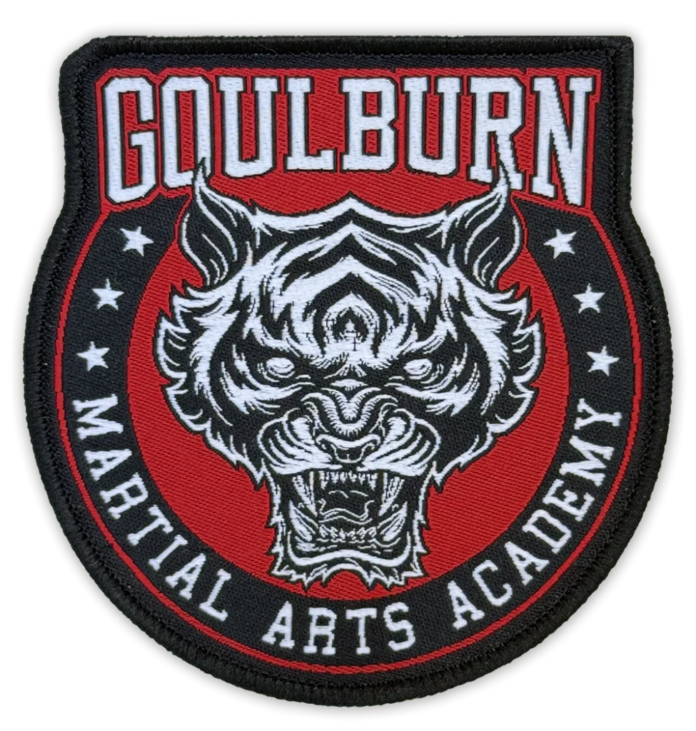 Custom woven martial arts badge for Goulburn Martial Arts Academy featuring fierce tiger head design in red black and white with bold lettering